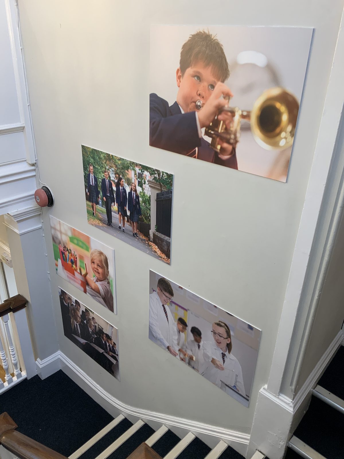 A wall of real pupil photography inside the school
